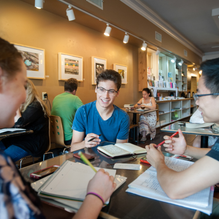 writing program for high school students Students around table working on and discusssing writing