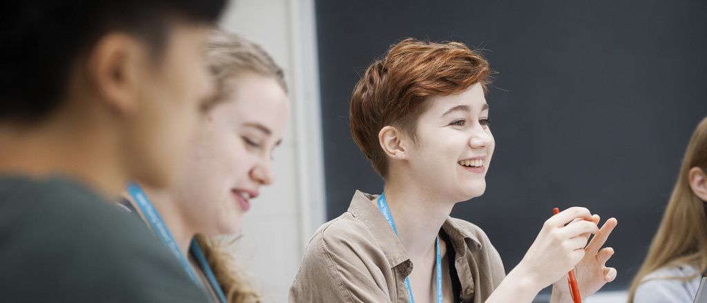 writing program for high school students Smiling student in classroom with other students
