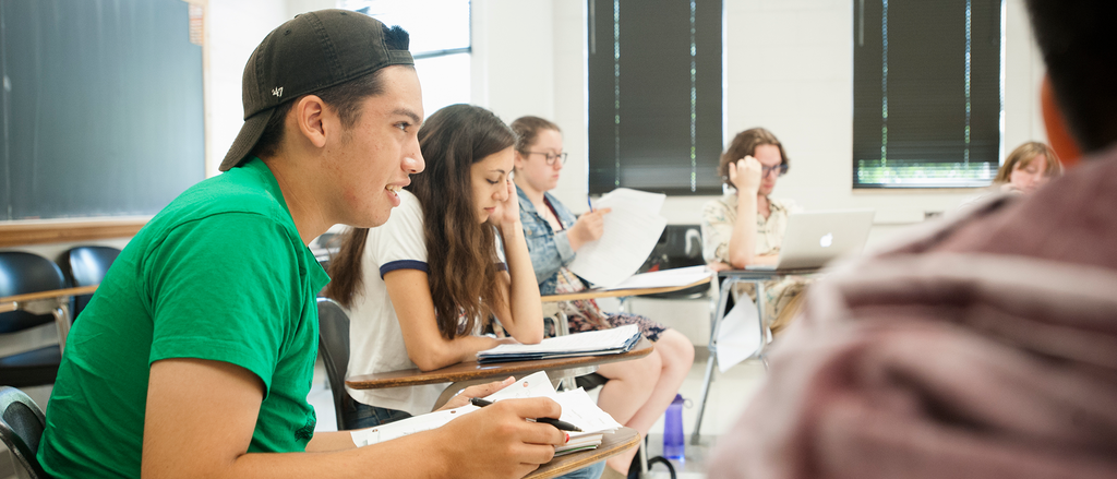 Student among peers in classroom at a desk