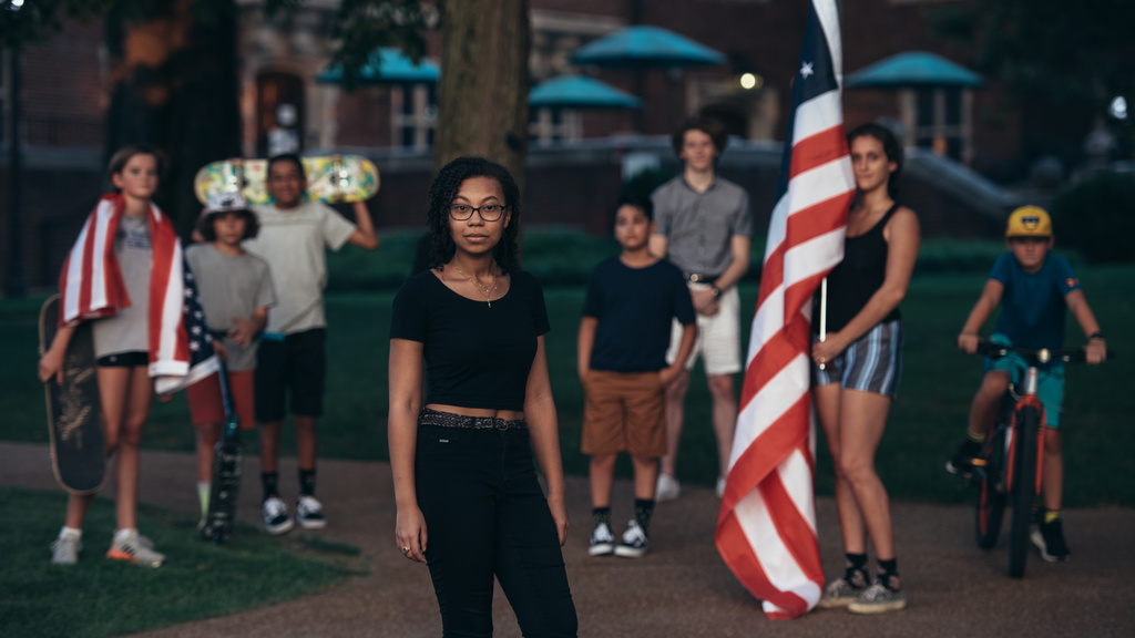 Group of teenagers in the street with American flag